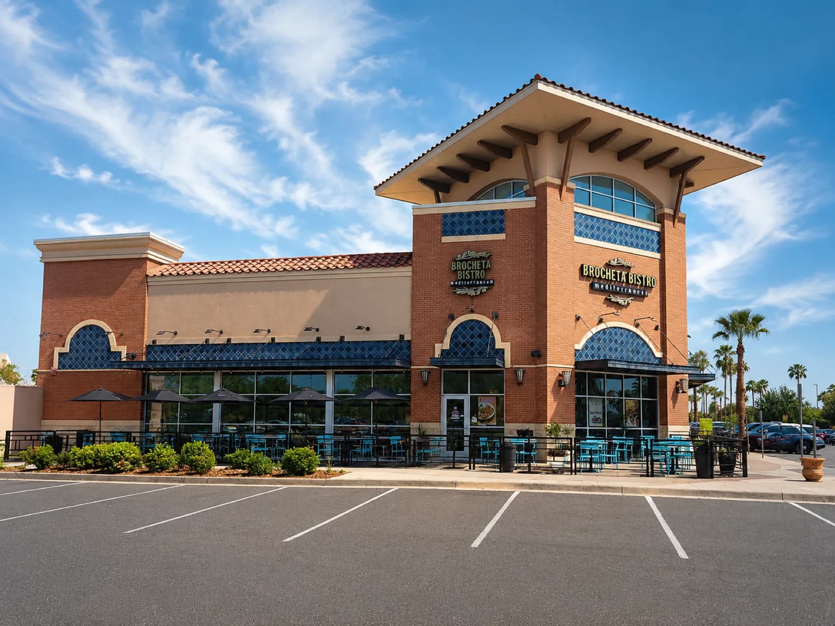 Brocheta Bistro in Palms Crossing, McAllen — brick tower, tiled roof and shaded patio seating